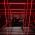 Stairwell wall and ceiling illuminated by red coloured LED linear strip lighting