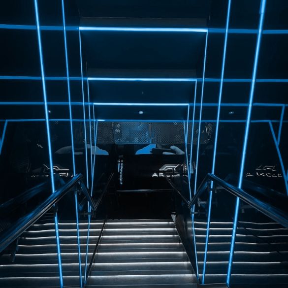 Stairwell wall and ceiling illuminated by blue coloured LED linear strip lighting